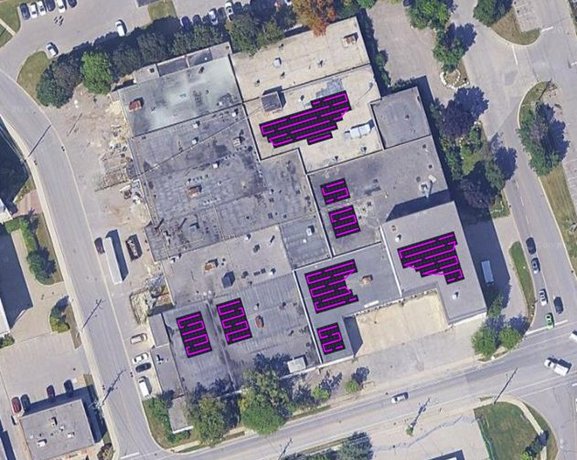 Aerial view of the 177 Mills Road facility with the modelled photovoltaic array placement overlaid in magenta across nine separate roof sections